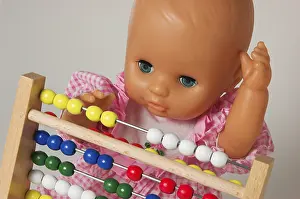 Educational Institution Concept Impressions: Learning arithmetics, doll using an abacus