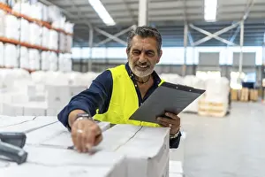 Barcode Scanner Impressions: Logistics manager smiling while using a barcode scanner