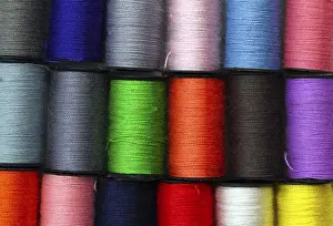 Empty Space Design Impressions: Lot of colored thread spools, background