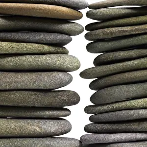 Deserted Beach Landscape Impressions: Low angle view of two flat pebble stone stacks in light back