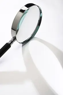 Close Up Concept Image Impressions: Magnifying glass casting a shadow
