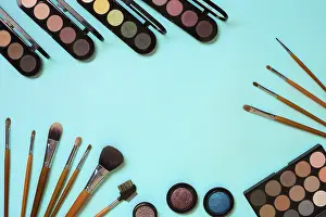 Blue Background Cosmetics Impressions: Make up essentials. Set of professional make up brushes