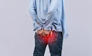 Digestive Problems Impressions: Man with digestive problem touching his buttock