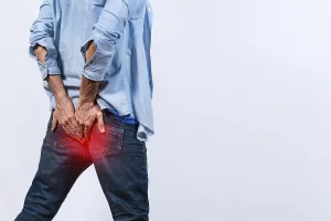 Digestive Issues Impressions: Man with digestive problem touching his buttock