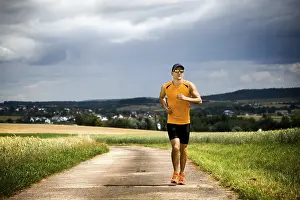 Fitness Man Impressions: Man jogging through the fields