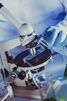 Scientist In Lab Impressions: Man is looking into the ocular of microscope