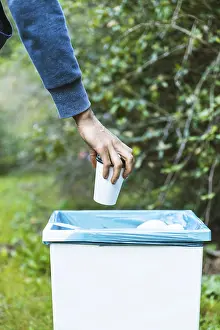 Environmental Protection Impressions: Man throwing up garbage bin