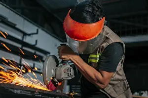 Handicraft Industry Impressions: Man using a grinder in a workshop