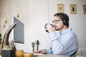 Modern Office Architecture Impressions: Man working computer drinking
