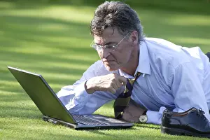 Caucasian Male Professional Impressions: Manager working on notebook in parc