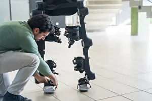 Exoskeleton Technology Impressions: Mechanical exoskeleton engineer checking robot before delivery to customer