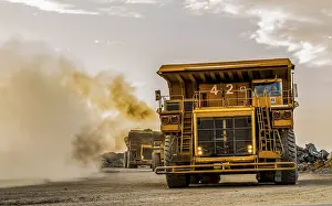 Construction Site Equipment Impressions: Mining dump trucks transporting Platinum ore for processing