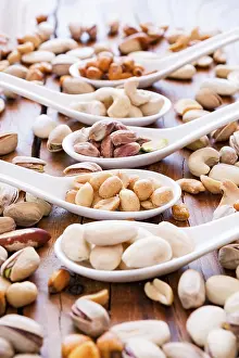 Deserted Table Scene Impressions: Mix of nuts over a rustic table in backlit