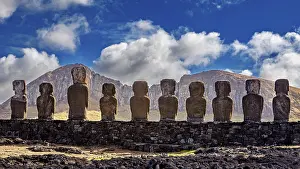 Dramatic Cloudy Skies Impressions: Moai statues against a mountain backdrop and dramatic sky with clouds