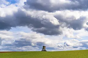 Deserted Farmland Germany Impressions: Mobile raised hide in an empty field under dramatic clouds