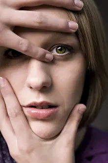 Blond Woman Looking At Camera Impressions: Model posing her hands around her face