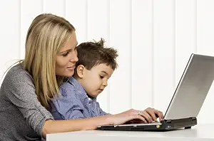 Mother Working From Home Impressions: Mother and son at the computer