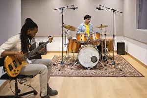 Musician Collaboration Impressions: Two musicians collaborating in a modern recording studio