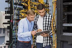 Medical Diagnosis Impressions: Network engineers with tablet medium shot