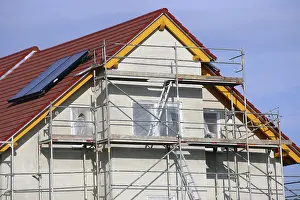 New Home Construction Process Impressions: New building with completed basic rendering of the exterior facade New building with completed basic rendering of
