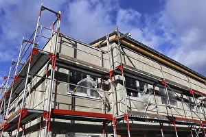Residential Construction Site Impressions: New building with completed basic rendering of the exterior facade New building with completed basic rendering of