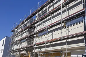 Residential Construction Site Impressions: New building with completed basic rendering of the exterior facade New building with completed basic rendering of