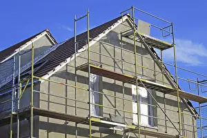 House Building Process Impressions: New building with completed basic rendering of the exterior facade New building with completed basic rendering of