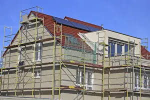 Residential Building Shell Construction Impressions: New building with completed basic rendering of the exterior facade New building with completed basic rendering of