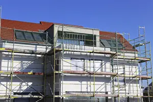 House Building Process Impressions: New building with completed basic rendering of the exterior facade New building with completed basic rendering of
