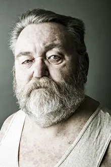 European Head Shot Impressions: Obese senior with a full beard and in his undershirt