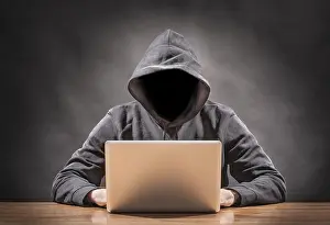 Computer Hacking Risks Impressions: picture of a hacker on a computer