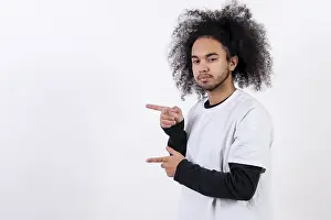 Hispanic Ethnicity Male Model Impressions: Pointing to the left at a copy paste space
