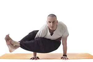 White Studio Photo Impressions: Practicing yoga trainer posing looking at camera