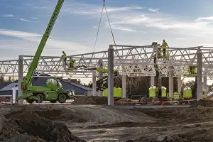 Industrial Construction Project Impressions: Professional construction crew using a telescopic handler