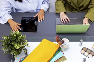 Professional Collaboration Impressions: Two professionals collaborate using technology devices