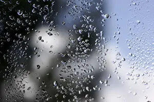 Cloudy Sky With Raindrops Impressions: Rain drops on window as the clouds clear behind