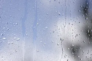 Raindrops On Window Impressions: Rain drops on window as the clouds clear behind