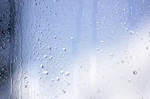 Cloudy Sky With Raindrops Impressions: Rain drops on window as the clouds clear behind
