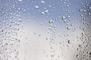 Cloudy Sky With Raindrops Impressions: Rain drops on window as the clouds clear behind