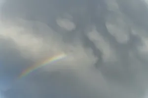 Cloudy Atmospheric Mood Impressions: Rainbow appears in rain clouds in spring