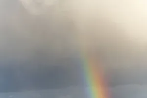Multicolored Cloudy Skies Impressions: Rainbow appears in rain clouds in spring