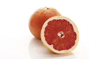 Close Up Citrus Fruit Impressions: Red grapefruit, Ruby Star, one whole and one half