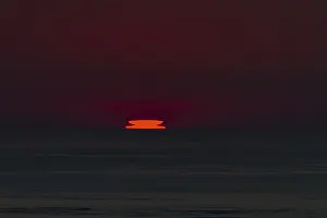 Evening Sun Setting Impressions: Refraction and reflection at sunset