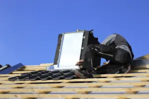 Construction Site Work Impressions: Roofer works on the chimney cladding