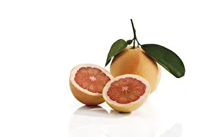 Studio Shot Fruits Impressions: Ruby Red grapefruit with stem and leaves