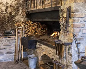 Traditional Craftsman Tools Impressions: A rustic blacksmith workshop featuring a burning forge