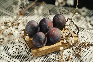 Delicate Flower Arrangement Impressions: A rustic composition of four uniquely painted Easter eggs