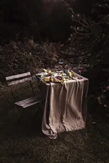 Lush Greenery Background Impressions: A rustic outdoor table set with an array of snacks