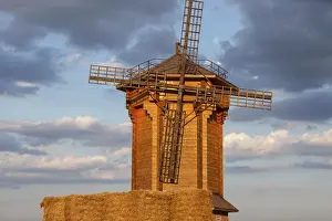 Evening Sun Setting Impressions: A rustic windmill is illuminated by sunset