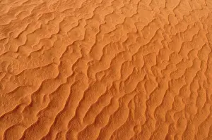 Desert Surface Texture Impressions: Sand patterns on the surface of a red dune